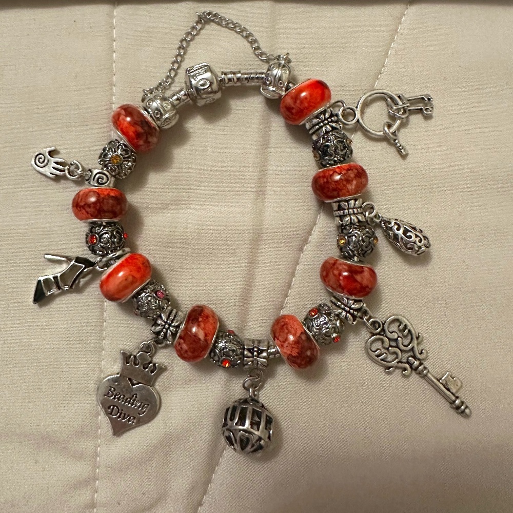 Handmade- NWOT -925 SS plated charm bracelet. 8Orange watercolor beads. Variety